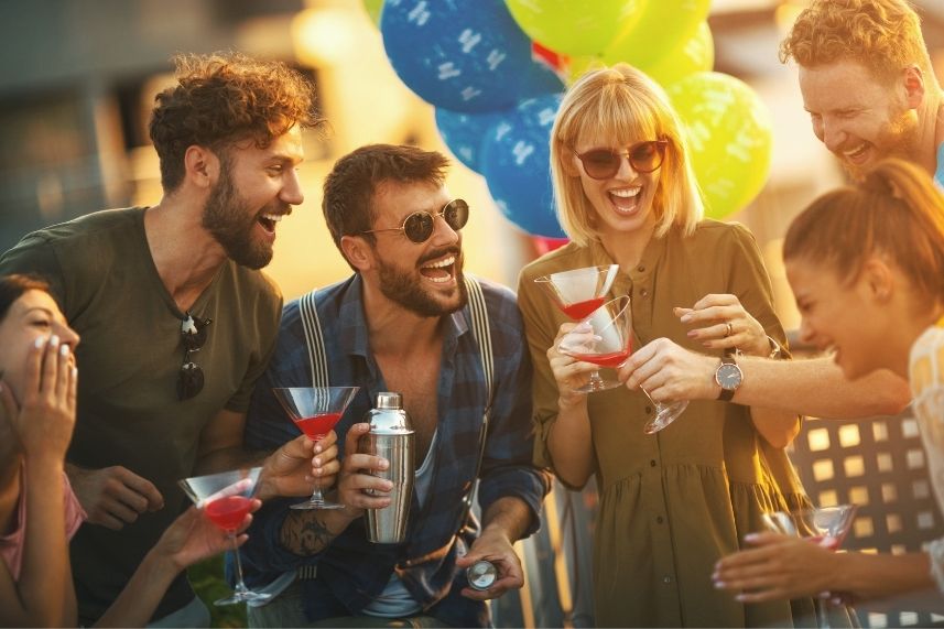 Un grupo de amigos disfrutando y riendo en una animada fiesta.